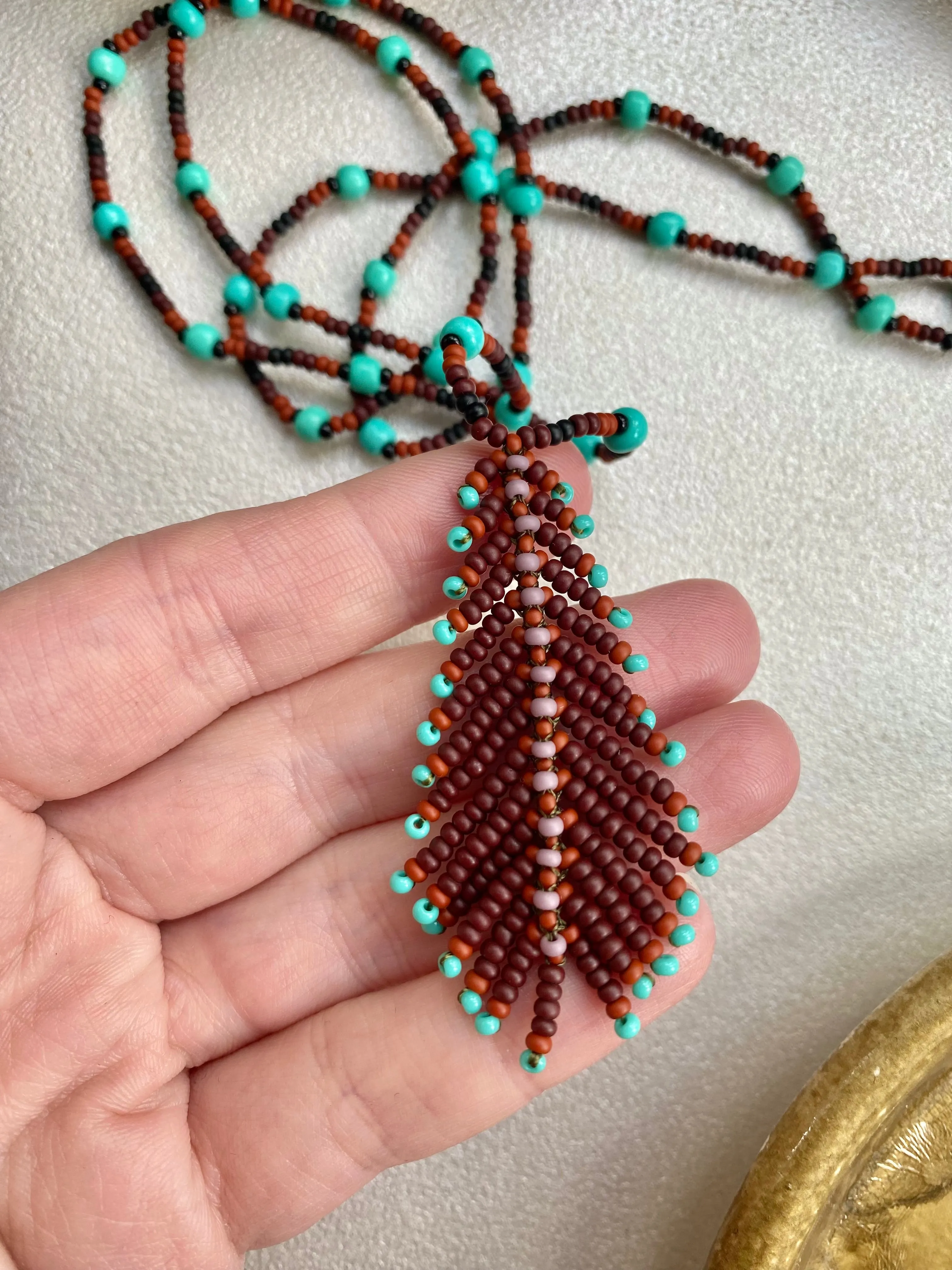 Handmade Seed Bead Feather Pendant Necklace for Women and Men in Boho Hippie style.